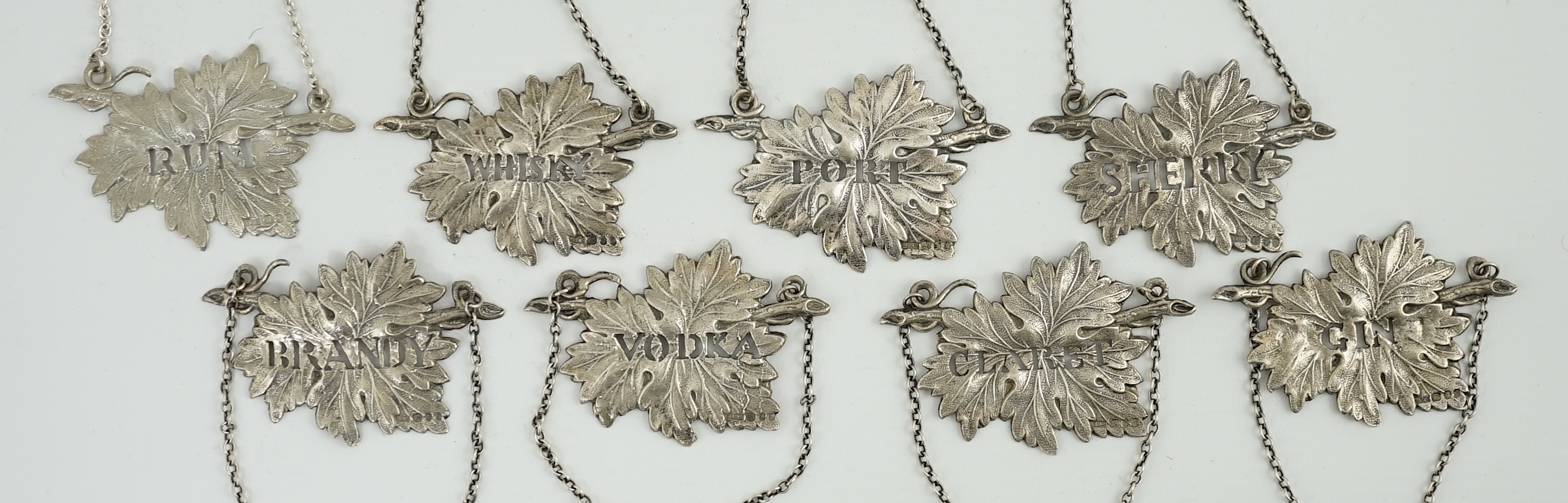 A set of eight Elizabeth II silver leaf wine labels, maker SMD